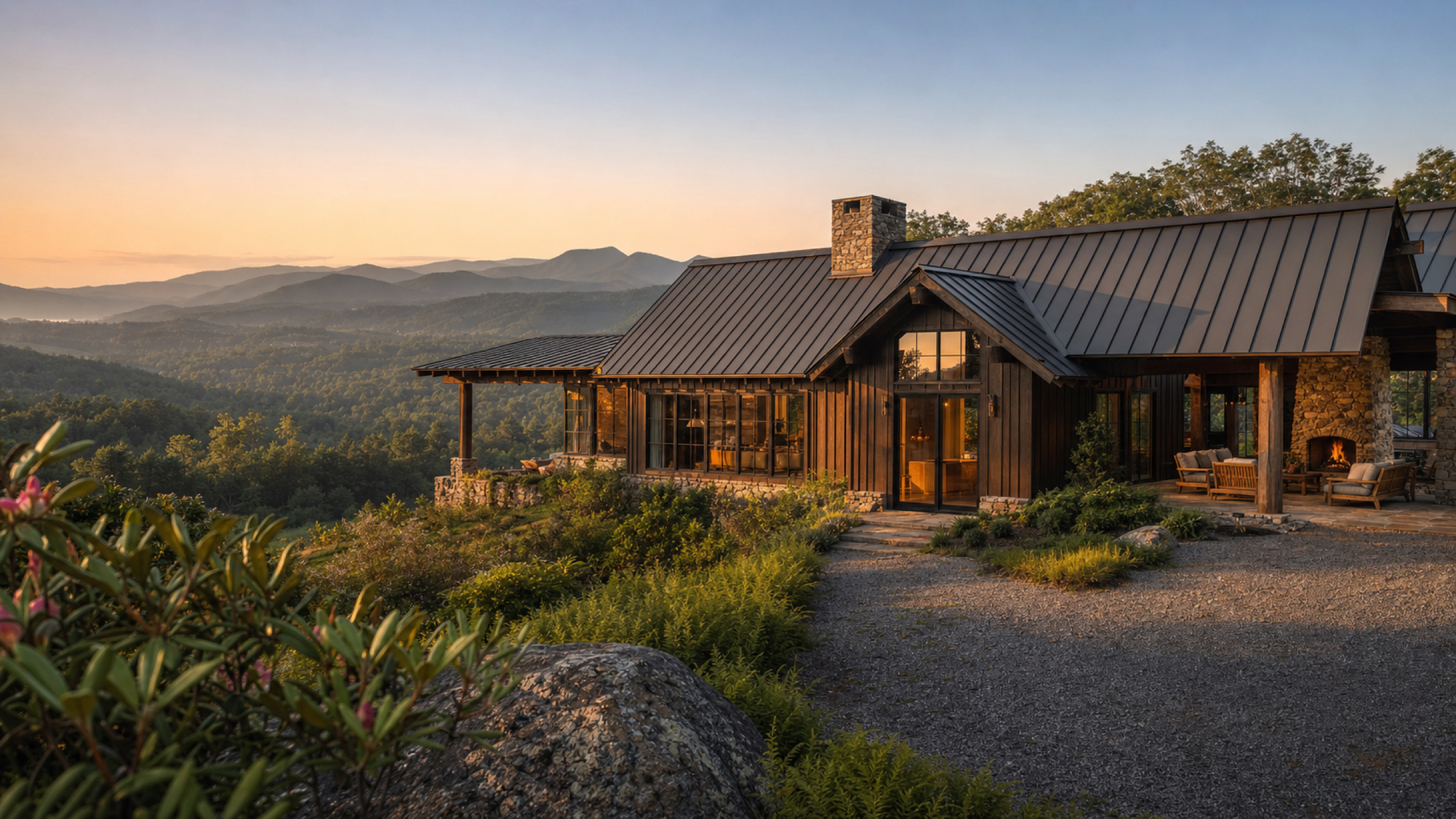 Mountain modern home of wood, stone, and glass at golden hour